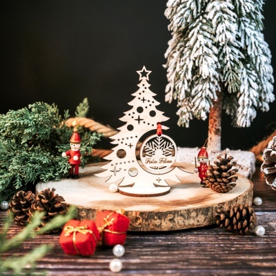 Árvore de Natal decorativa em madeira com texto Festas Felizes, decorada com pinhas, figuras de madeira e presentes vermelhos