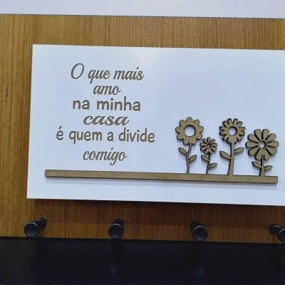 Placa decorativa em madeira com texto em português e flores em madeira.