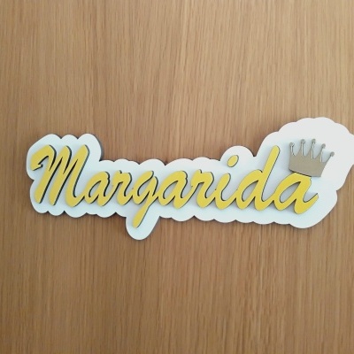 Placa decorativa de madeira com o nome Margarida e uma coroa