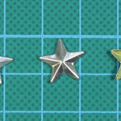 Três estrelas metálicas pequenas, duas prateadas e uma dourada
