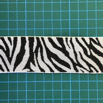 Fita decorativa padrão zebra preto e branco sobre grelha azul