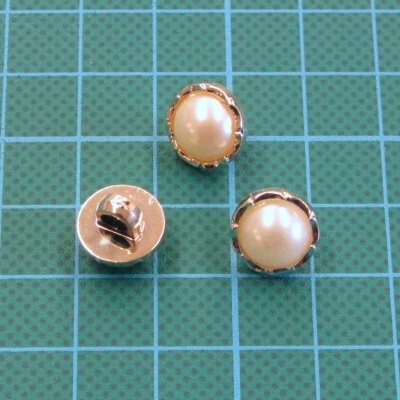 Botões redondos creme com moldura dourada em fundo azul-esverdeado