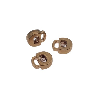 Três prendedores de cabo dourados de metal com formato arredondado