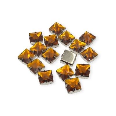 Pedras quadradas facetadas cor âmbar com base metálica prateada em fundo branco