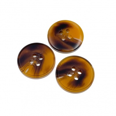 Três botões redondos castanhos com padrões pretos sobre fundo branco