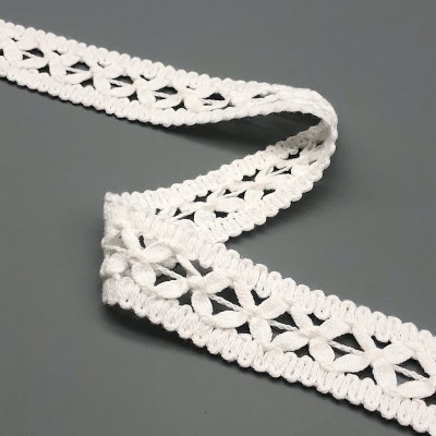 Renda branca em padrão de flores sobre fundo cinzento