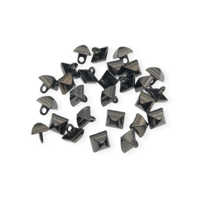 Tachas metálicas pretas em forma de pirâmide sobre fundo branco