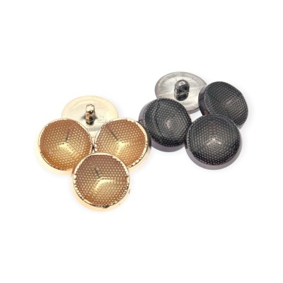 Botões redondos dourados e pretos com textura de pontos sobre fundo branco
