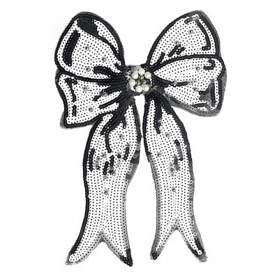 Aplicação decorativa de laço branco e preto com brilhos