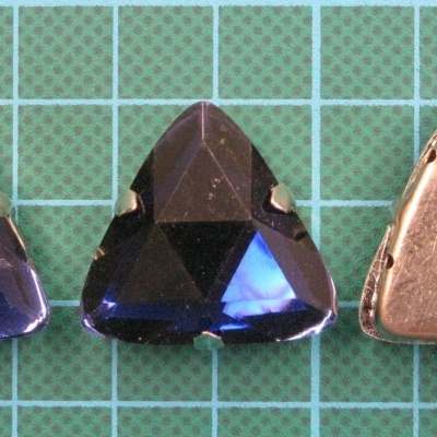 Botões triangulares azuis escuros facetados em base verde quadriculada