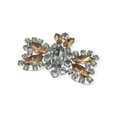 Broche em forma de laço com pedras castanhas e transparentes