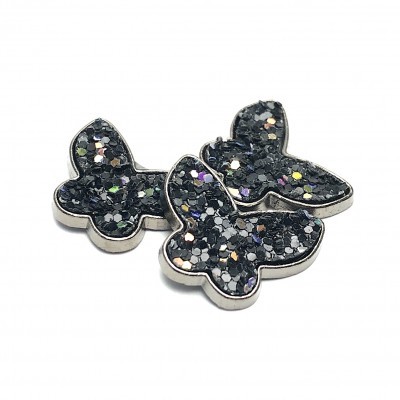 Três borboletas prateadas com glitter negro e brilhantes coloridos