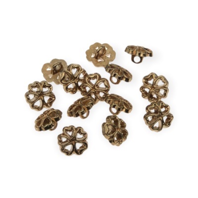 Botões metálicos dourados em forma de flores sobre fundo branco