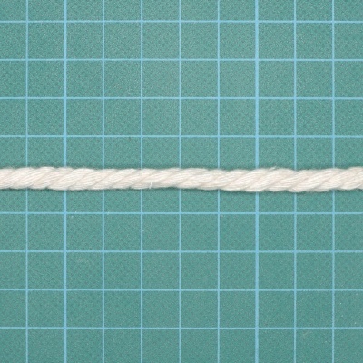 Cordão branco torcido sobre base verde com grelha azul e preta