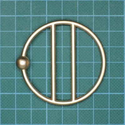 Forma metálica redonda dourada com barras e esfera sobre superfície quadriculada azul verde