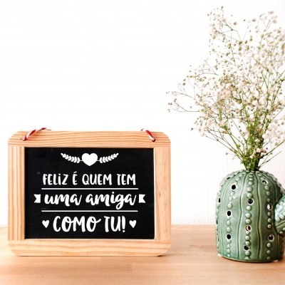 Quadro com mensagem em português e vaso em forma de cacto com flores