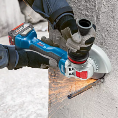 Esmerilhadora elétrica a cortar barra de metal numa parede