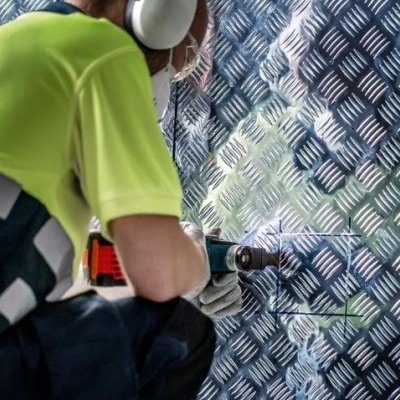 Homem a polir chapa metálica antiderrapante