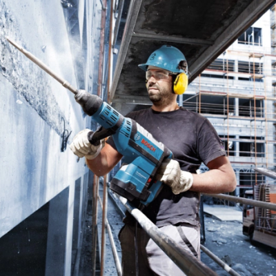 Homem a usar ferramenta Bosch numa obra de construção civil