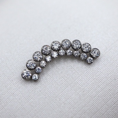 Brilhantes ou cristais redondos dispostos em curva sobre tecido branco