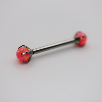 Piercing corporal com bolas vermelhas e detalhes pretos