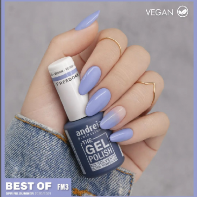 Frasco de verniz gel azul escuro segurado por mão com unhas lilás e azul claro