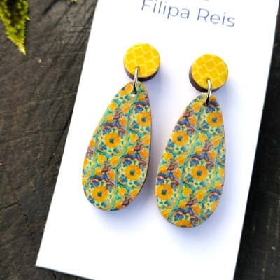 Brincos coloridos pendentes em cartão com texto Filipa Reis