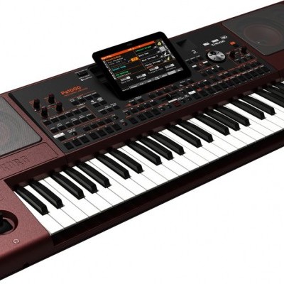 Teclado musical KORG PA5X bordô com ecrã tátil e várias controls.