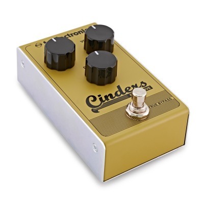 Pedal de efeito para guitarra dourado com três botões pretos e botão de pé prateado