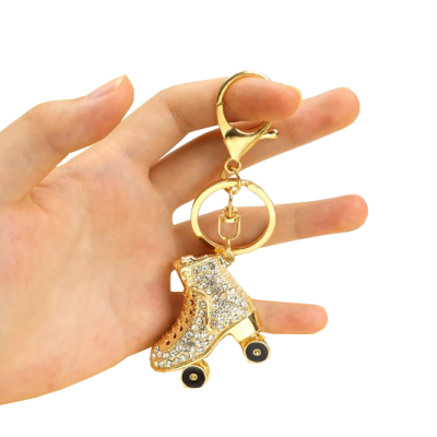 Chaveiro patim dourado com brilhantes