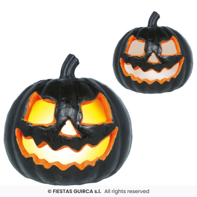 Abóboras decorativas pretas de Halloween iluminadas com recortes de olhos e boca