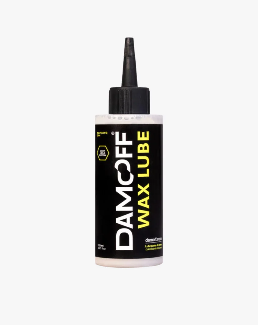 Frasco de lubrificante Damcoff Wax Lube com rótulo preto e detalhes amarelos