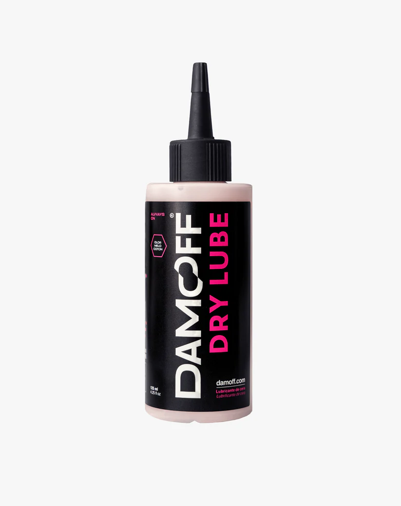 Frasco de lubrificante Damcoff Dry Lube com etiqueta preta e rosa