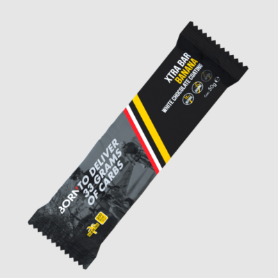 Barra alimentar XTRA BAR BANANA com cobertura de chocolate branco na embalagem preta e cinza