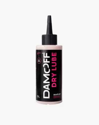 Frasco de lubrificante Damcoff Dry Lube com etiqueta preta e rosa