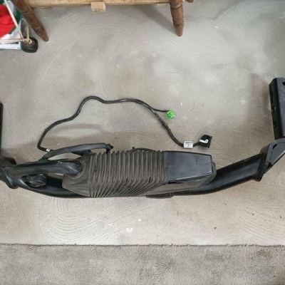 Peça automática preta com cabos sobre tapete cinza claro