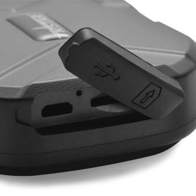 Dispositivo electrónico cinzento com porta USB e tampa de borracha preta aberta