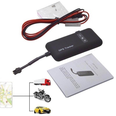 Rastreador GPS preto com cabos e manual em fundo branco
