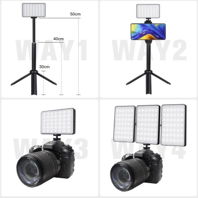 Tripé preto com luz LED ajustável e equipamentos fotográficos