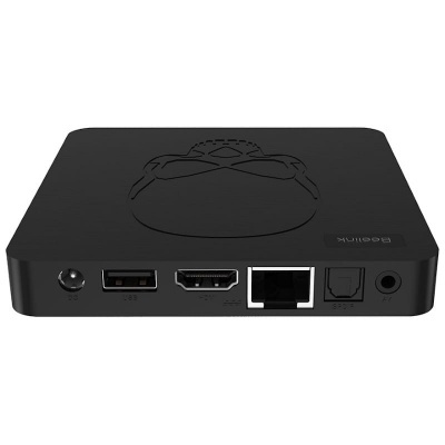 Aparelho multimédia preto com várias portas de conexão e padrão em relevo no topo.