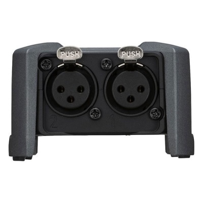 Conector de áudio com duas entradas circulares pretas com botões PUSH em corpo cinzento escuro.