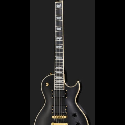 Guitarra elétrica preta tipo Les Paul com detalhes dourados