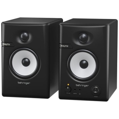 Par de colunas de estúdio Behringer pretas com cones cinzentos e botões na coluna direita