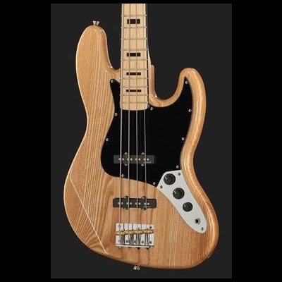 Baixo elétrico em madeira clara com tampo preto e controlo branco