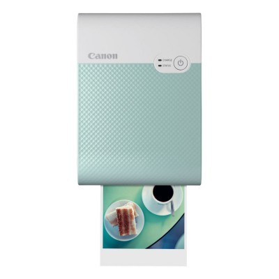 Impressora fotográfica portátil Canon a imprimir foto de bolo e café