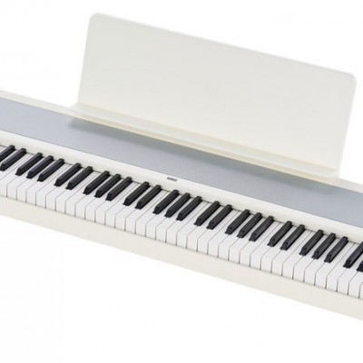 Teclado musical digital branco com teclas e suporte para partituras