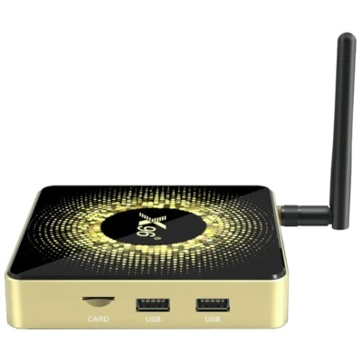 Media player dourado com antena preta, portas USB, slot para cartão e padrão circular no topo