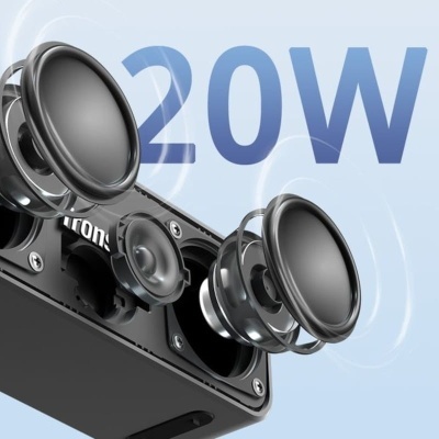 Coluna de som preta com woofers e texto 20W ao fundo