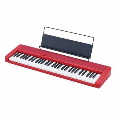 Teclado musical eletrônico vermelho com suporte para partituras