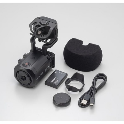 Câmara digital preta com acessórios sobre fundo branco